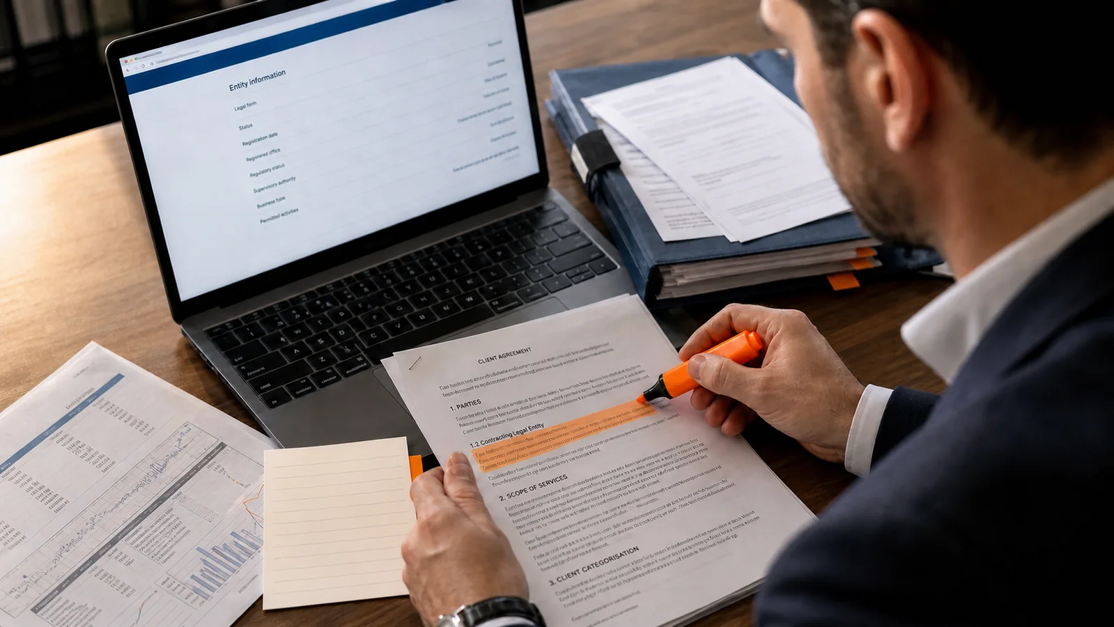 A financial professional highlights the contracting legal entity in a broker agreement while checking an official register